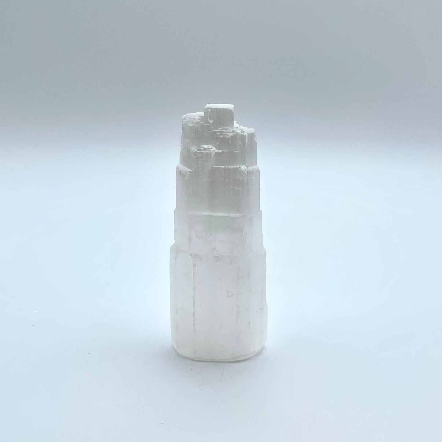 Selenite Tower in grey background