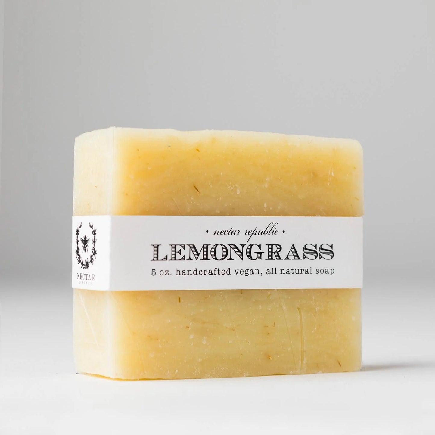 Bar of lemongrass soap with a label on a gray background
