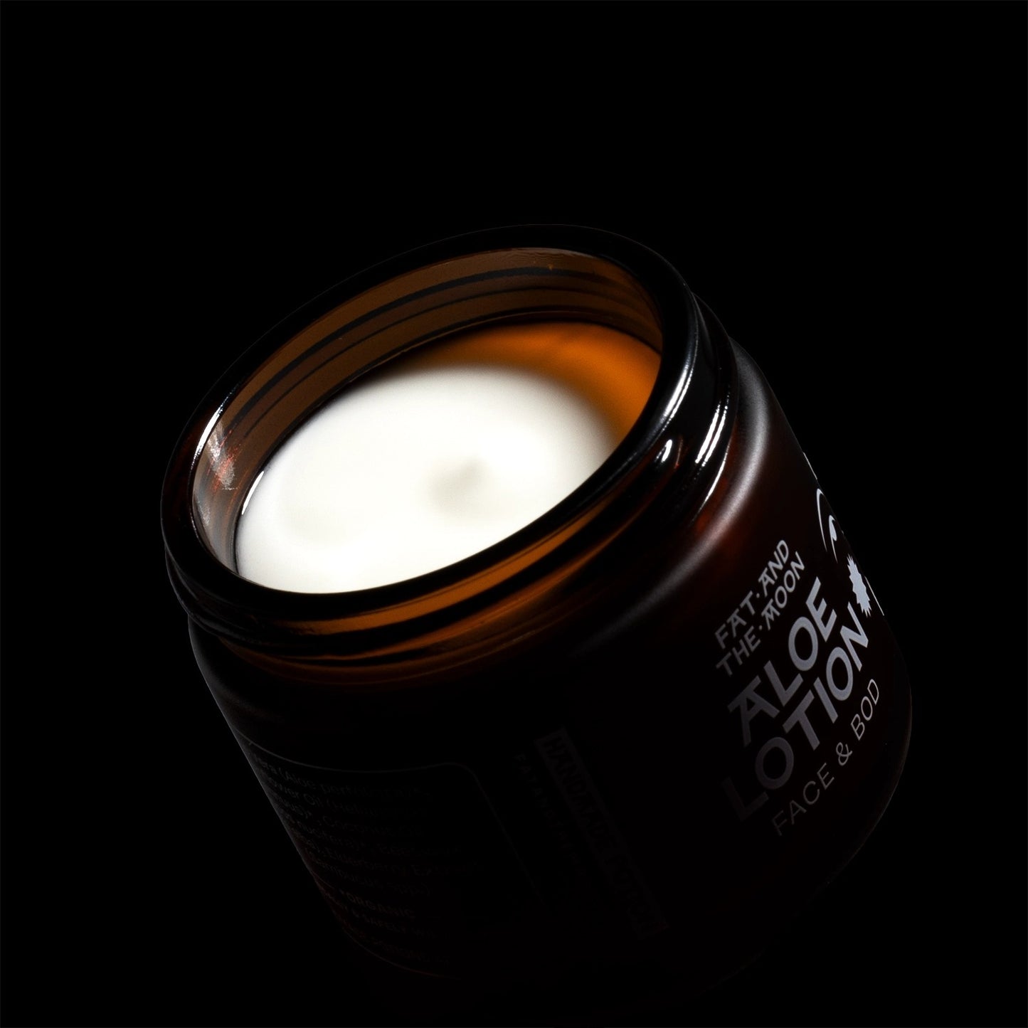Jar of aloe lotion with a black background