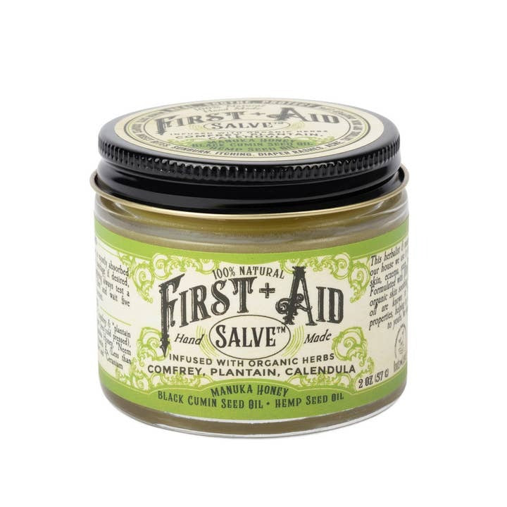 Jar of First Aid Hand Salve with green and black label on a white background