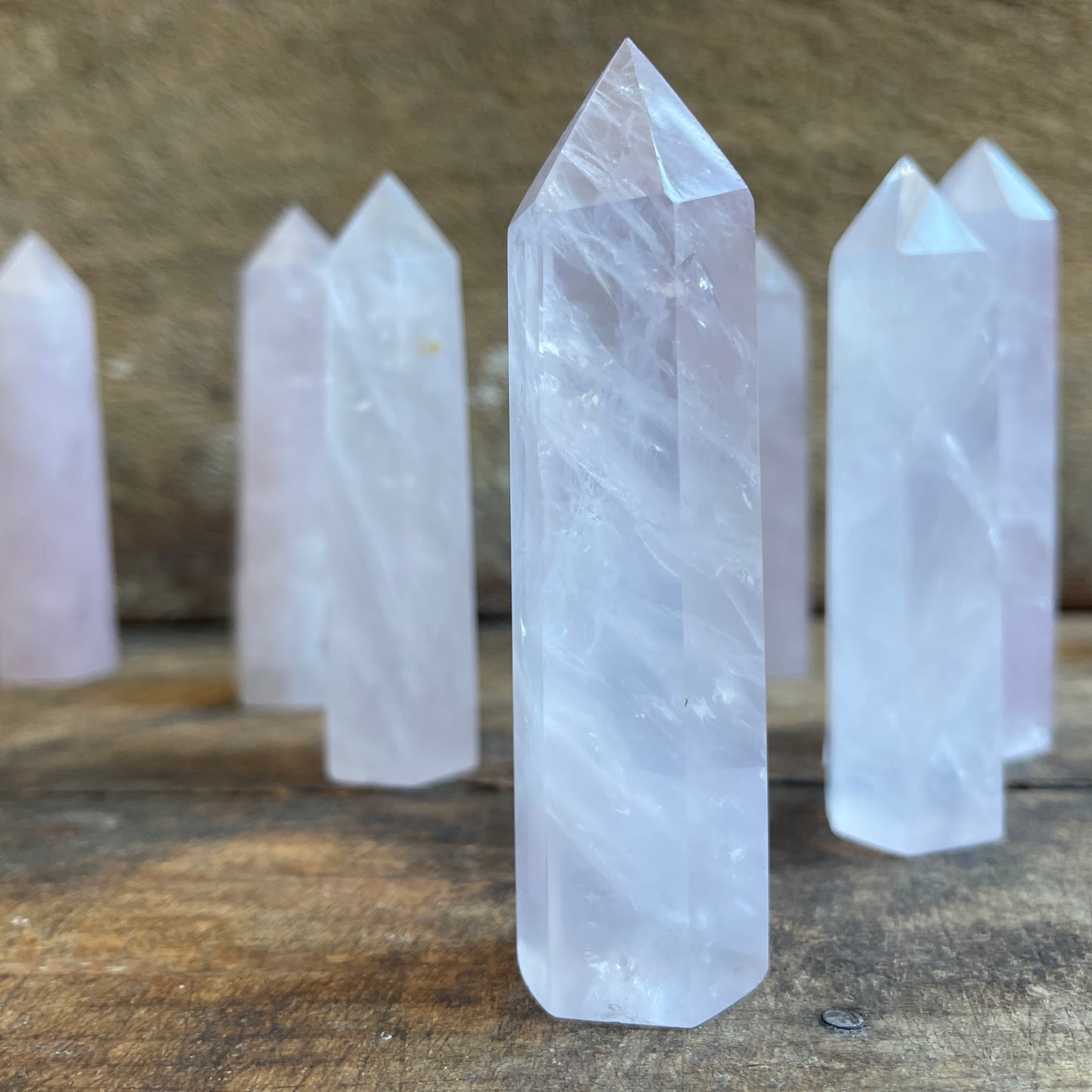 Rose quartz points on a wooden surface