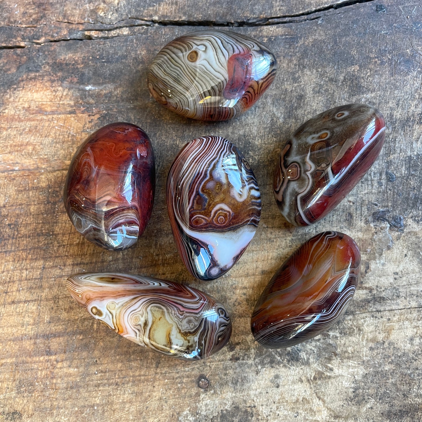 Patterned stones on a wooden surface