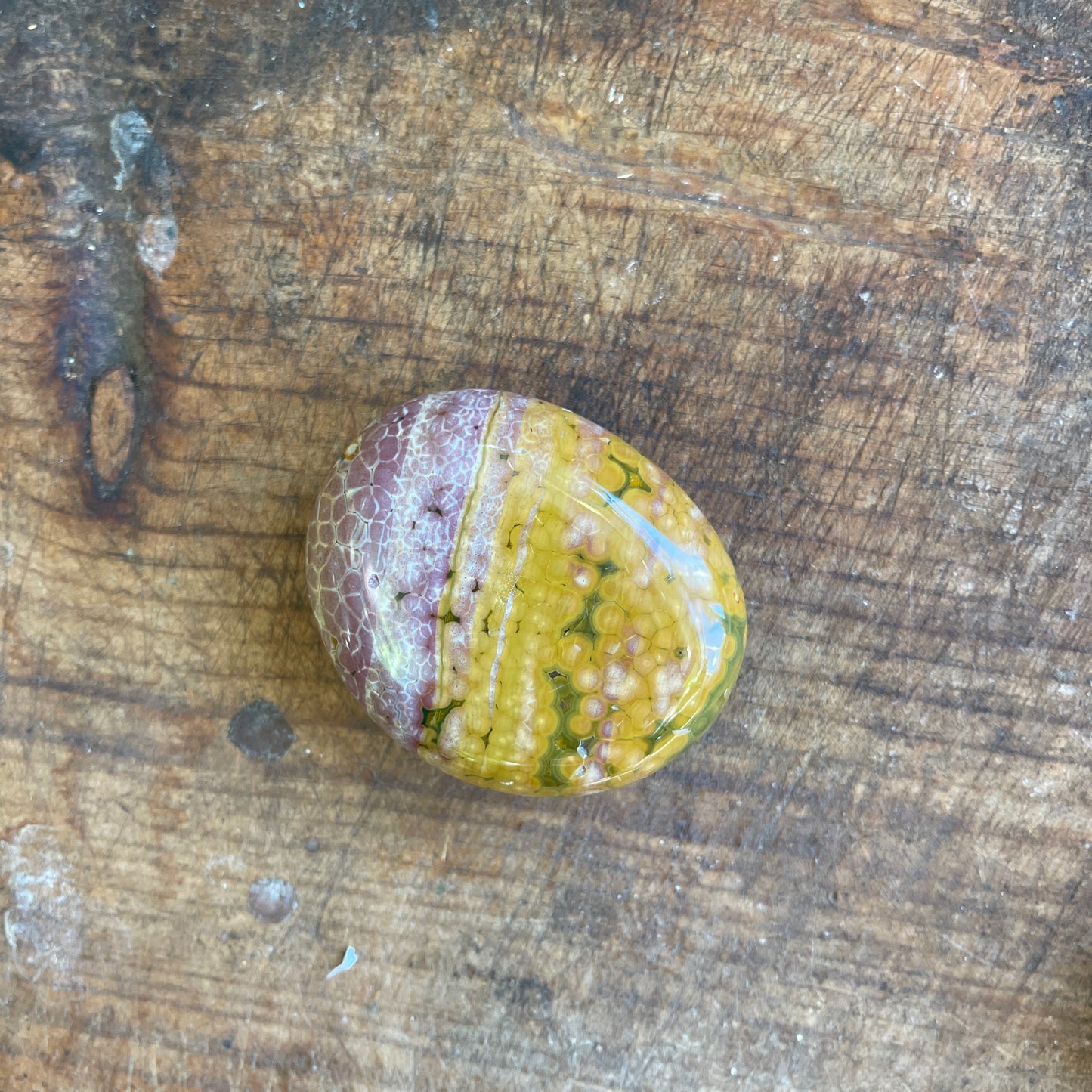 Multicolored stone on a wooden surface