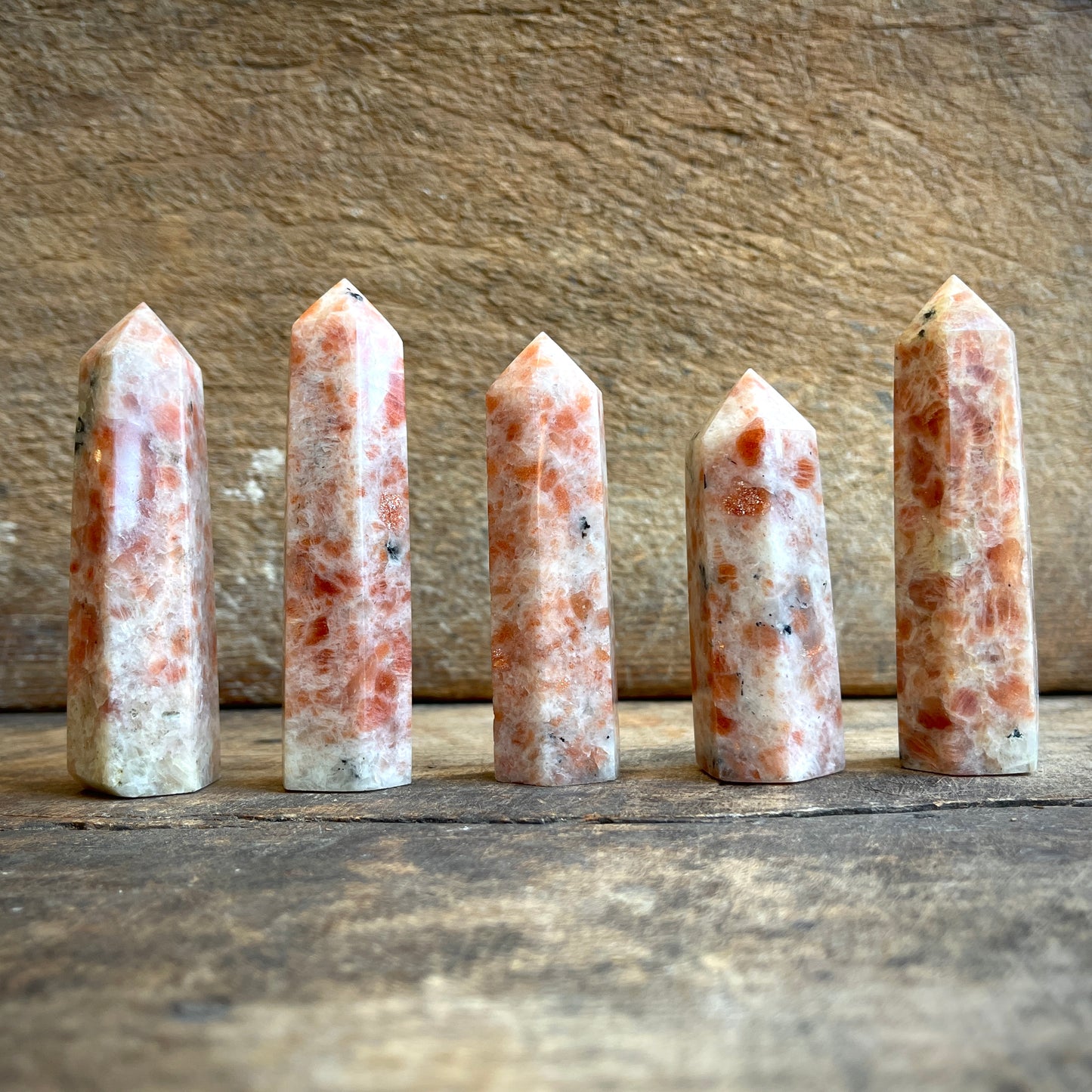 Sunstone points on a wooden surface