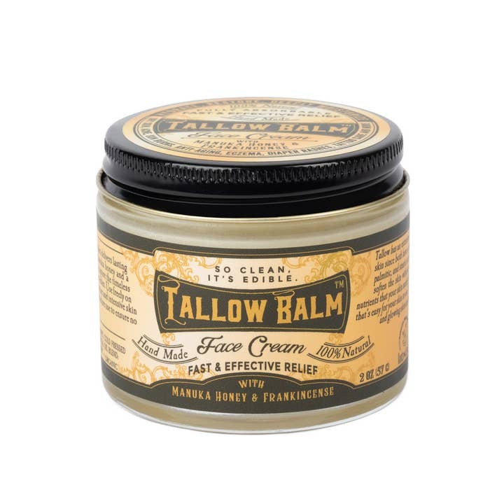 Tallow balm in a small jar with a black lid, on a white background