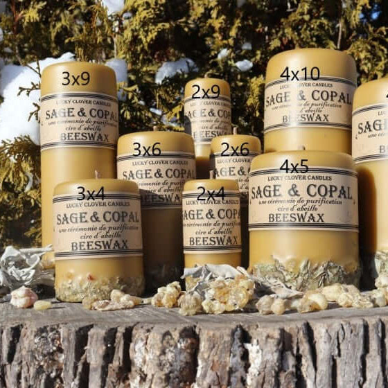 Stacks of Sage & Copal Beeswax containers on a wooden surface with natural background