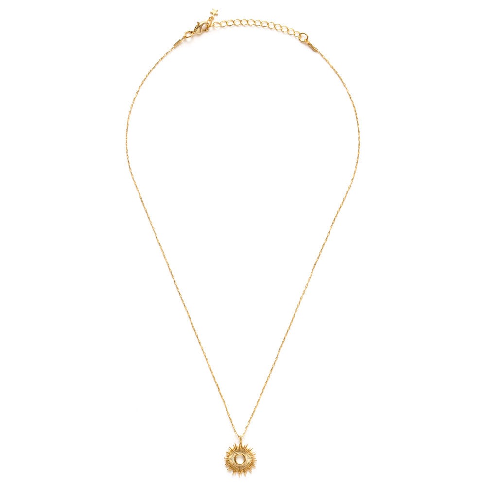 Gold necklace with a sun pendant on a white background