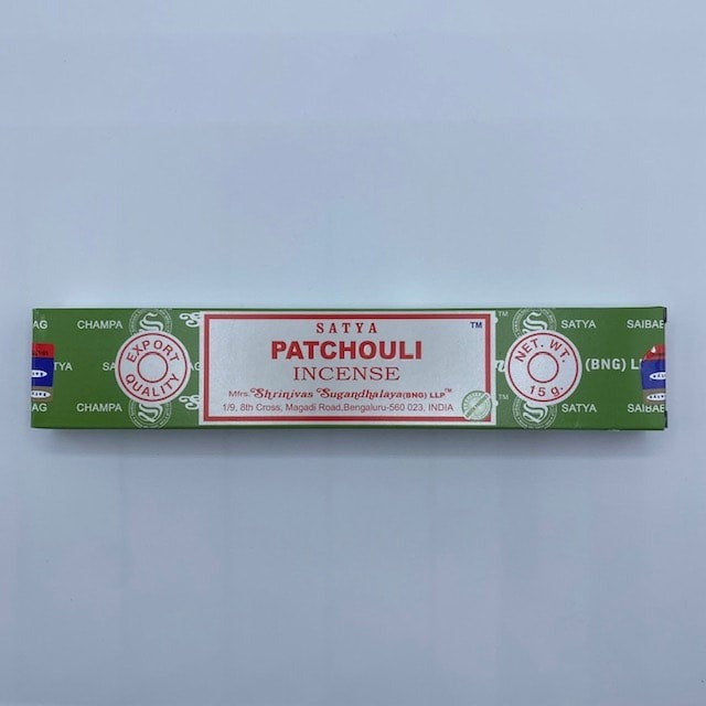 white, green and red incense box on grey background