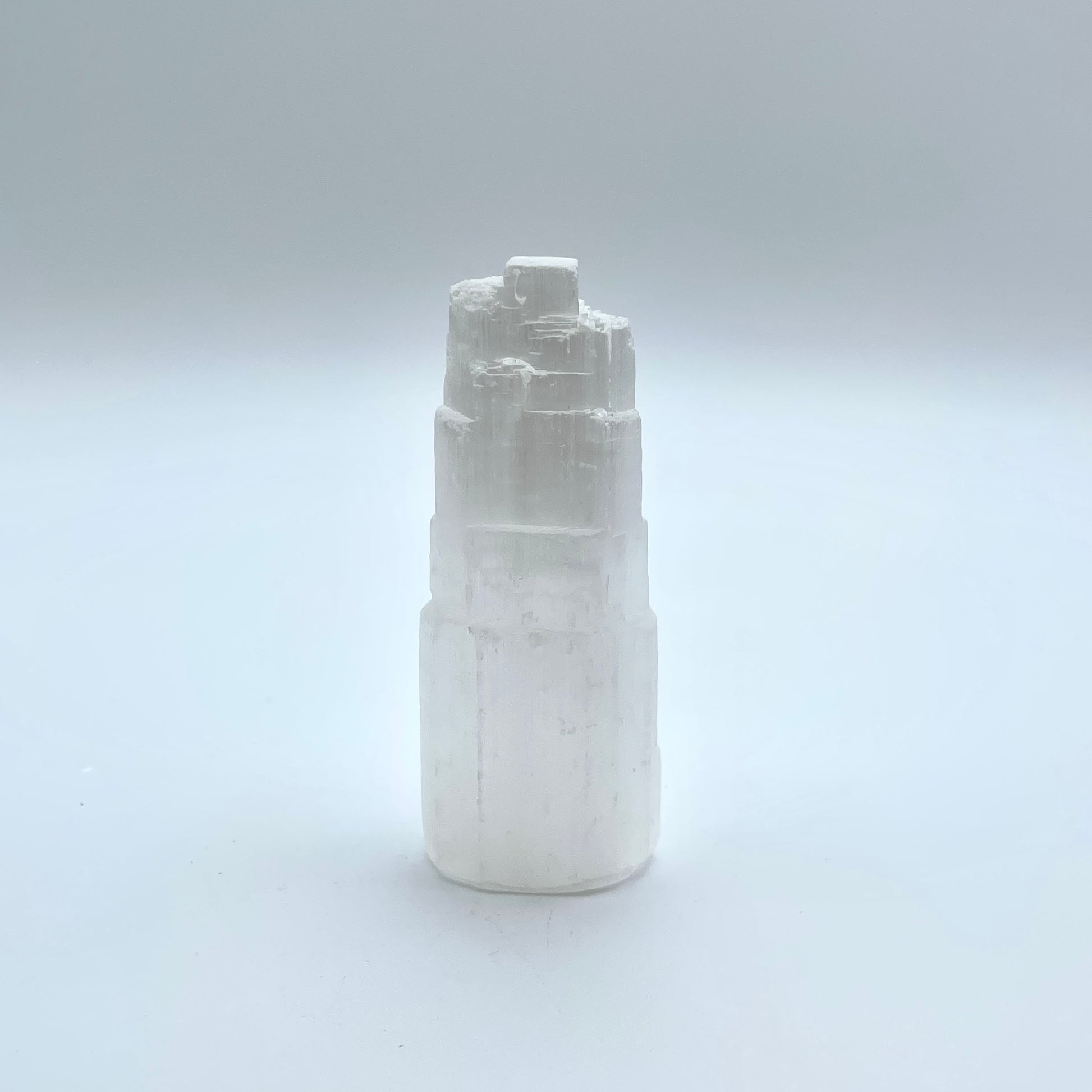 Selenite Tower in grey background