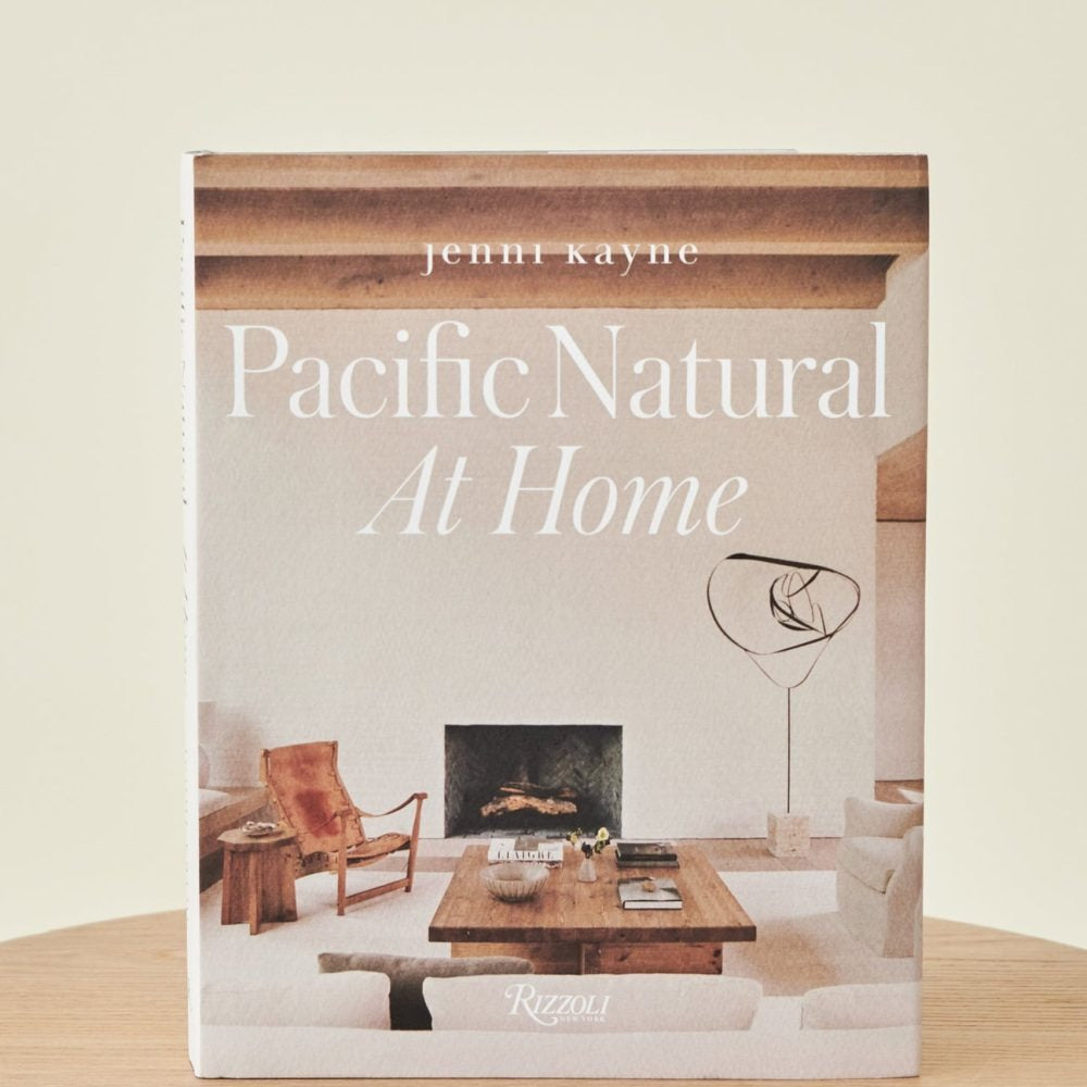 A coffee table book titled 'Pacific Natural At Home' by Jenni Kayne, featuring photographs of interior design.