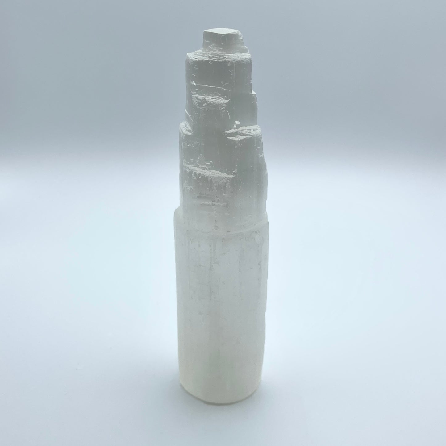 Selenite Tower on gray background