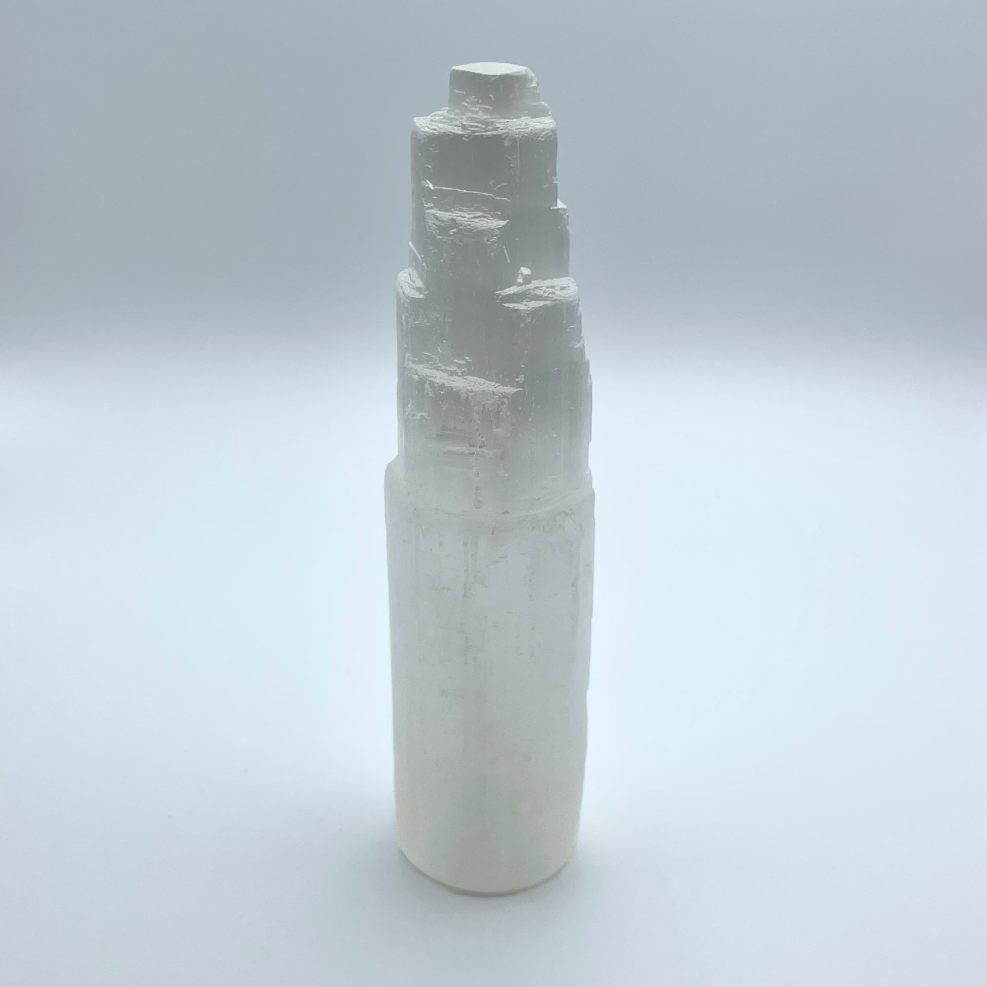 Selenite Tower on gray background