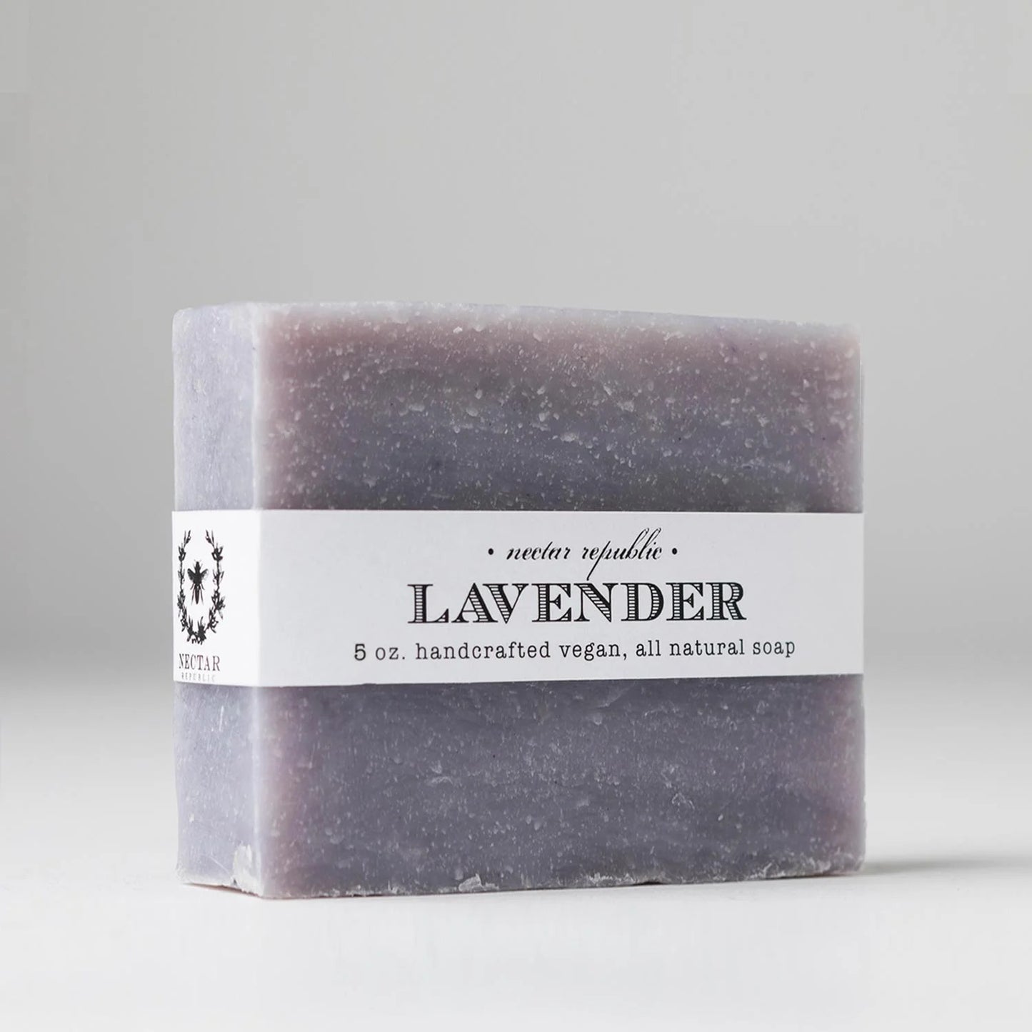 Lavender soap bar with a white label on a light gray background