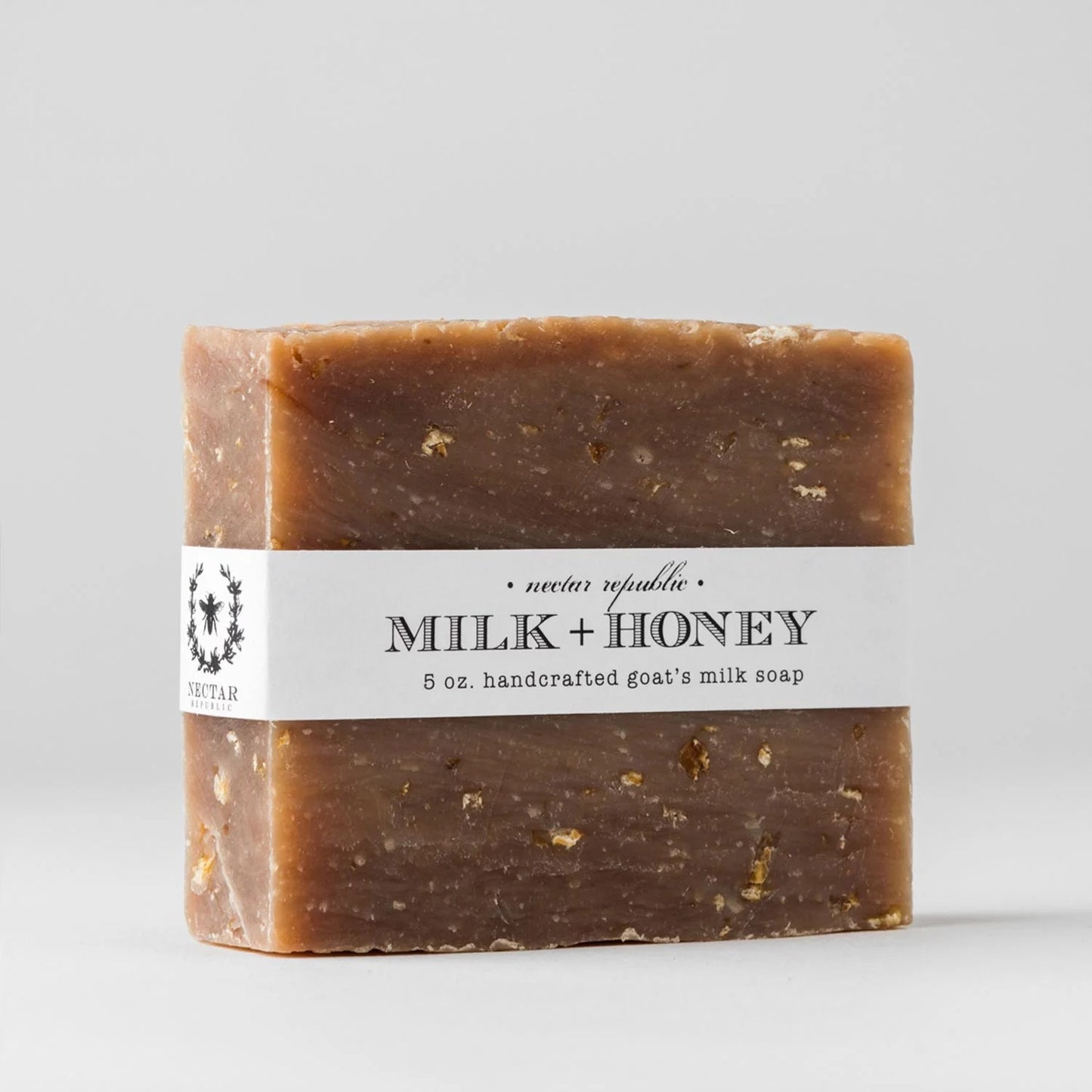 Bar of soap labeled 'Milk + Honey' with a white background