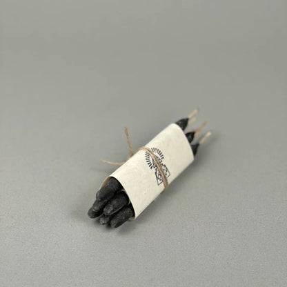 6 black resin incense sticks wrapped with jute in white paper with a logo on a gray background