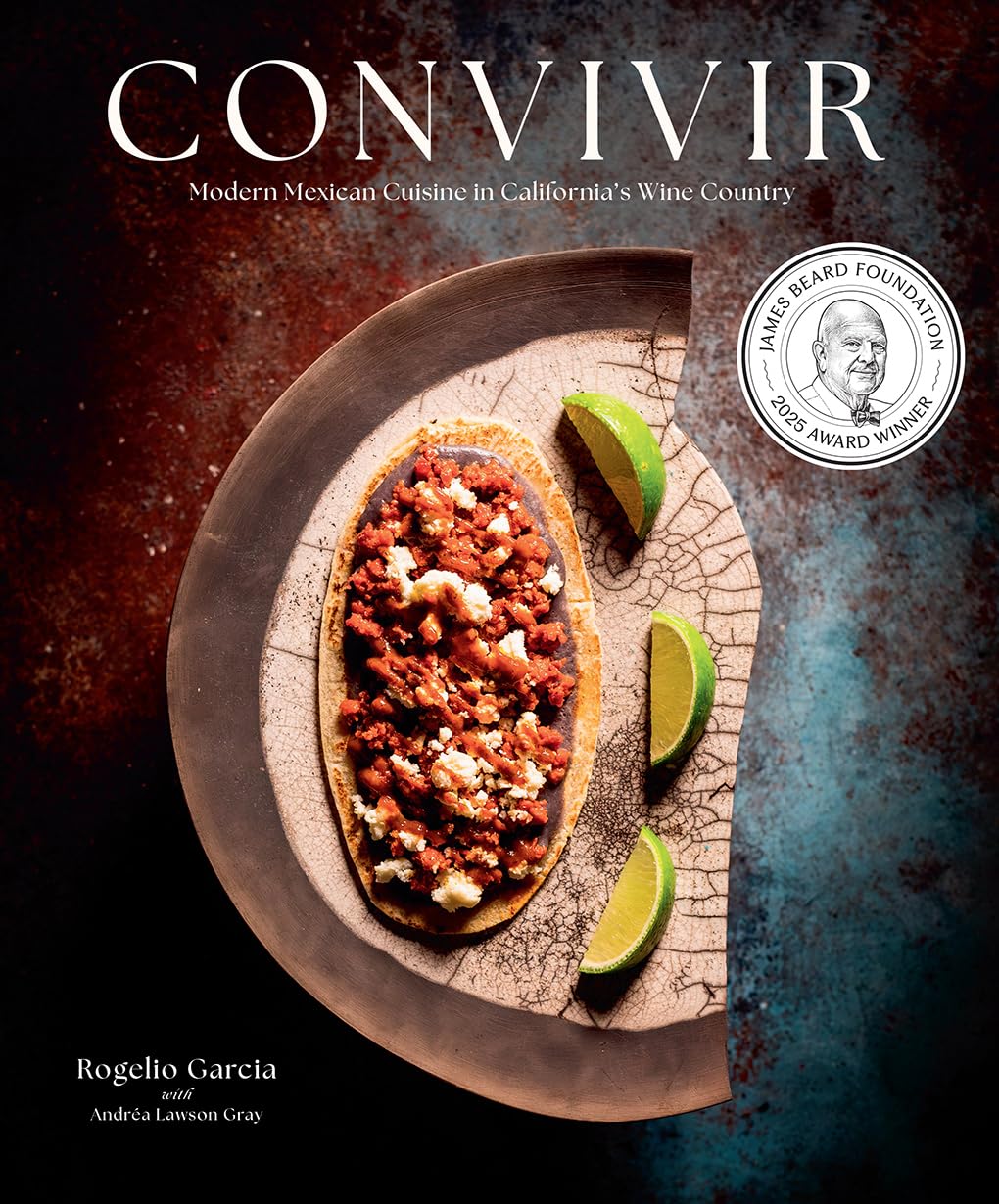 Book cover of 'Convivir' with a dish and limes on a textured surface, featuring a Michelin star logo.