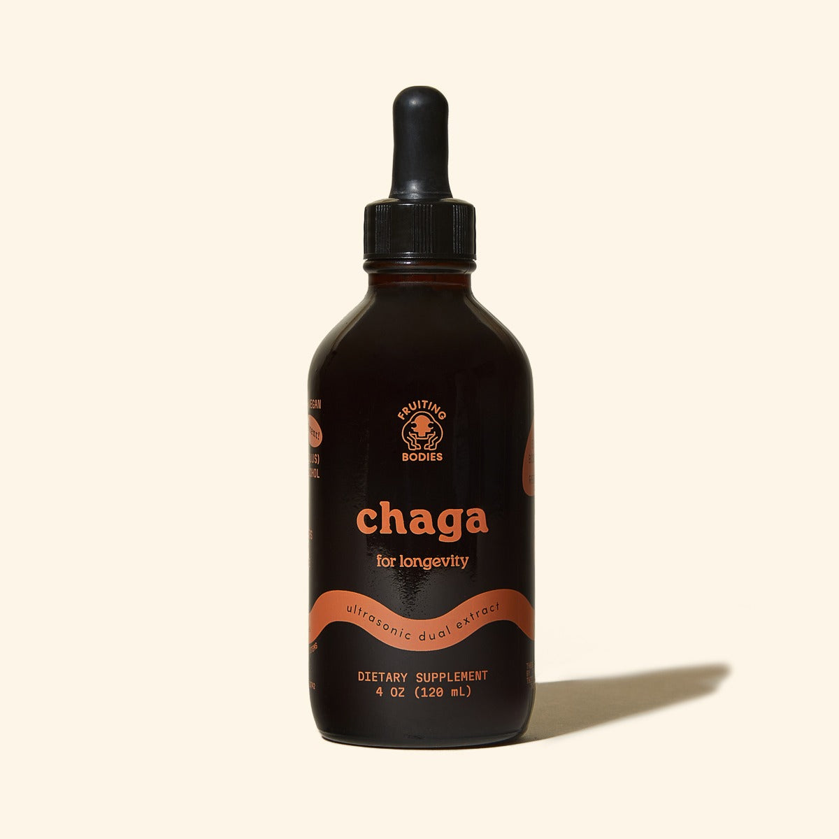 Bottle of chaga supplement with dropper on a beige background