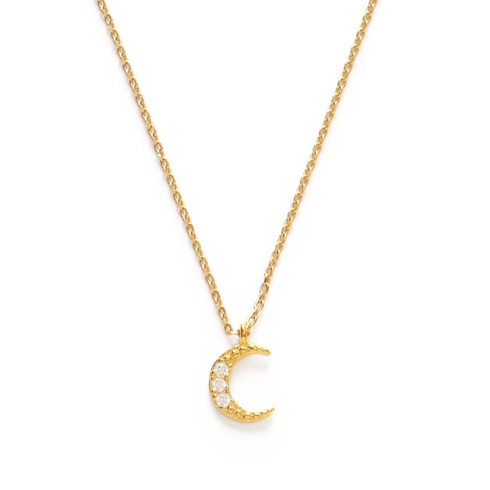 Gold necklace with a crescent moon pendant on a white background