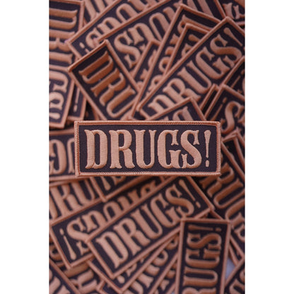 Patch with 'DRUGS!' text on a brown background