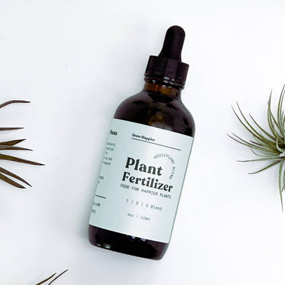 Bottle of plant fertilizer with a dropper on a white background