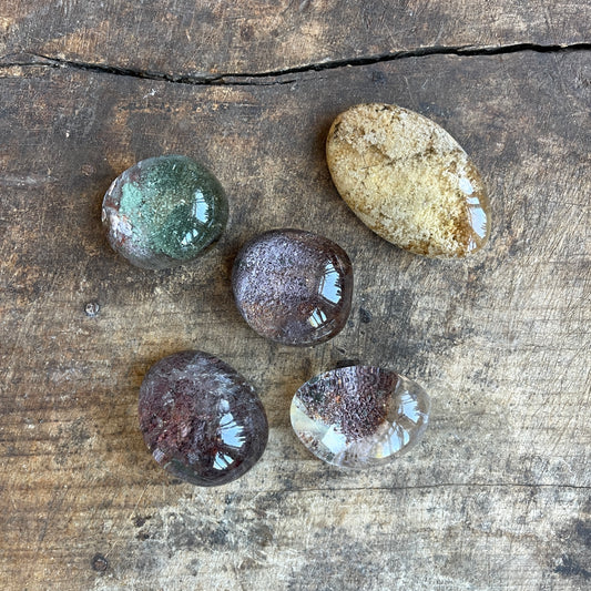 Five translucent crystal balls on a wooden surface