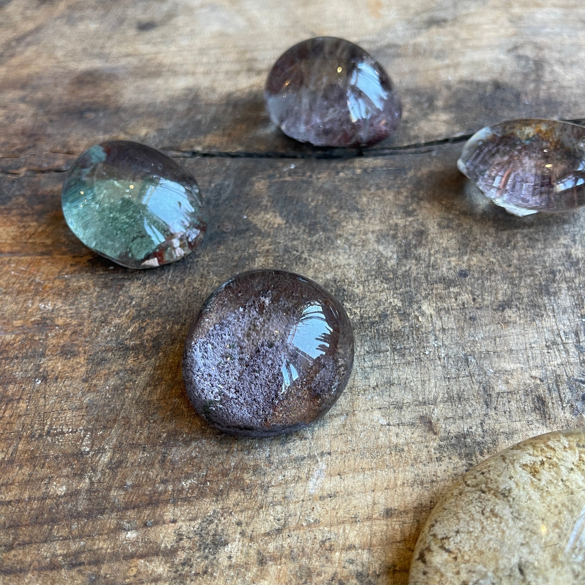 Round translucent stones on a wooden surface