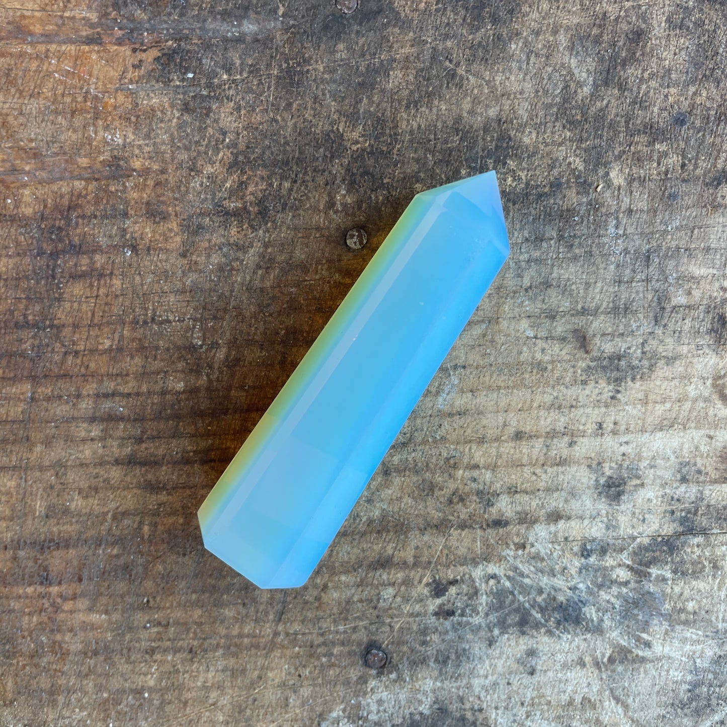 Opalite crystal on a wooden surface