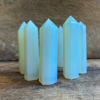 Multiple opalite crystal points on a wooden surface