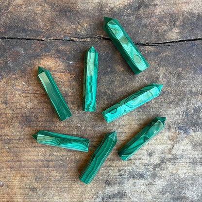 malachite points on a wooden surface