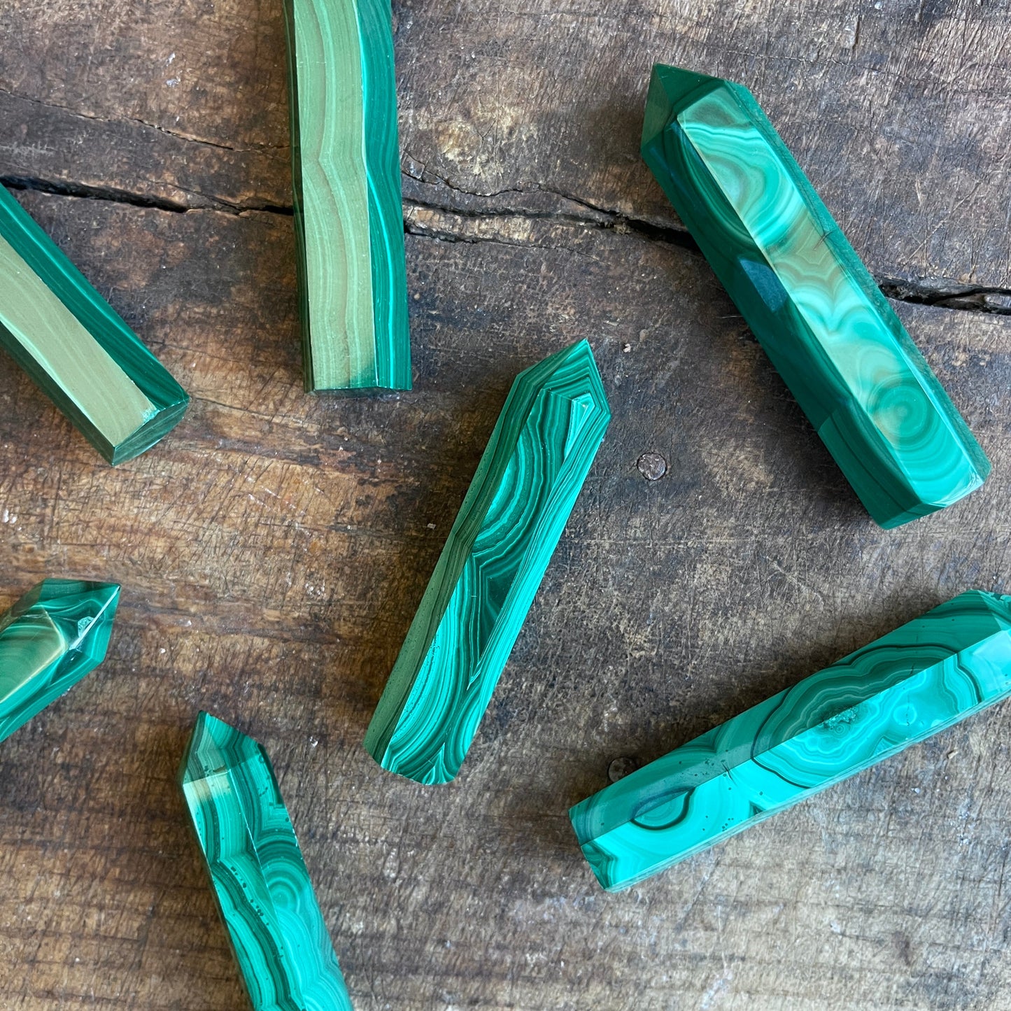 malachite points on a wooden surface