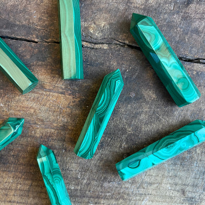 malachite points on a wooden surface
