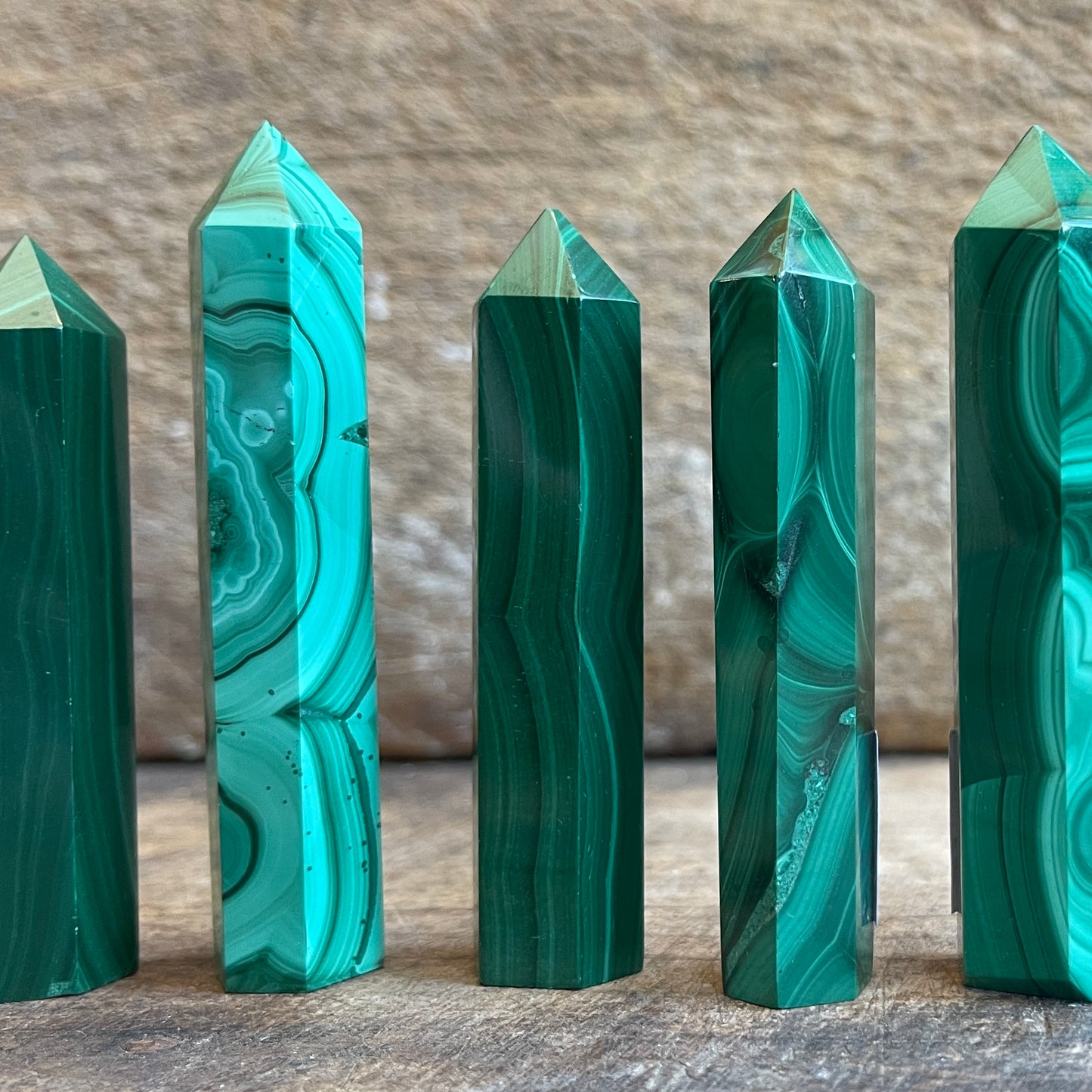 malachite points on a wooden surface