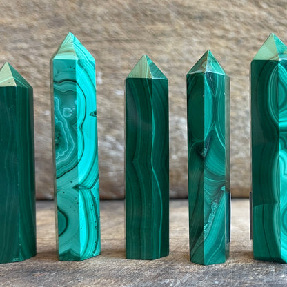 malachite points on a wooden surface