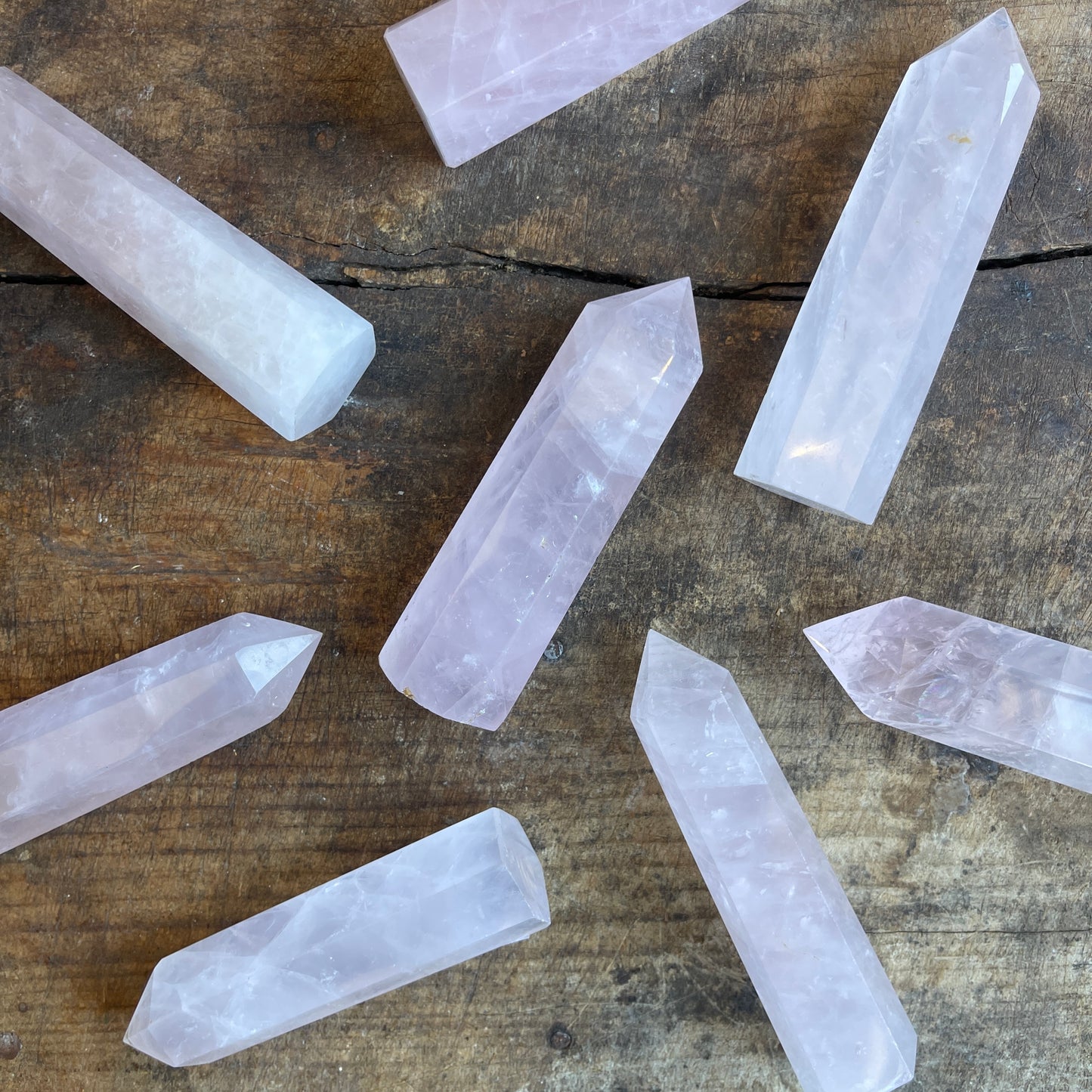 Rose quartz points on a wooden surface