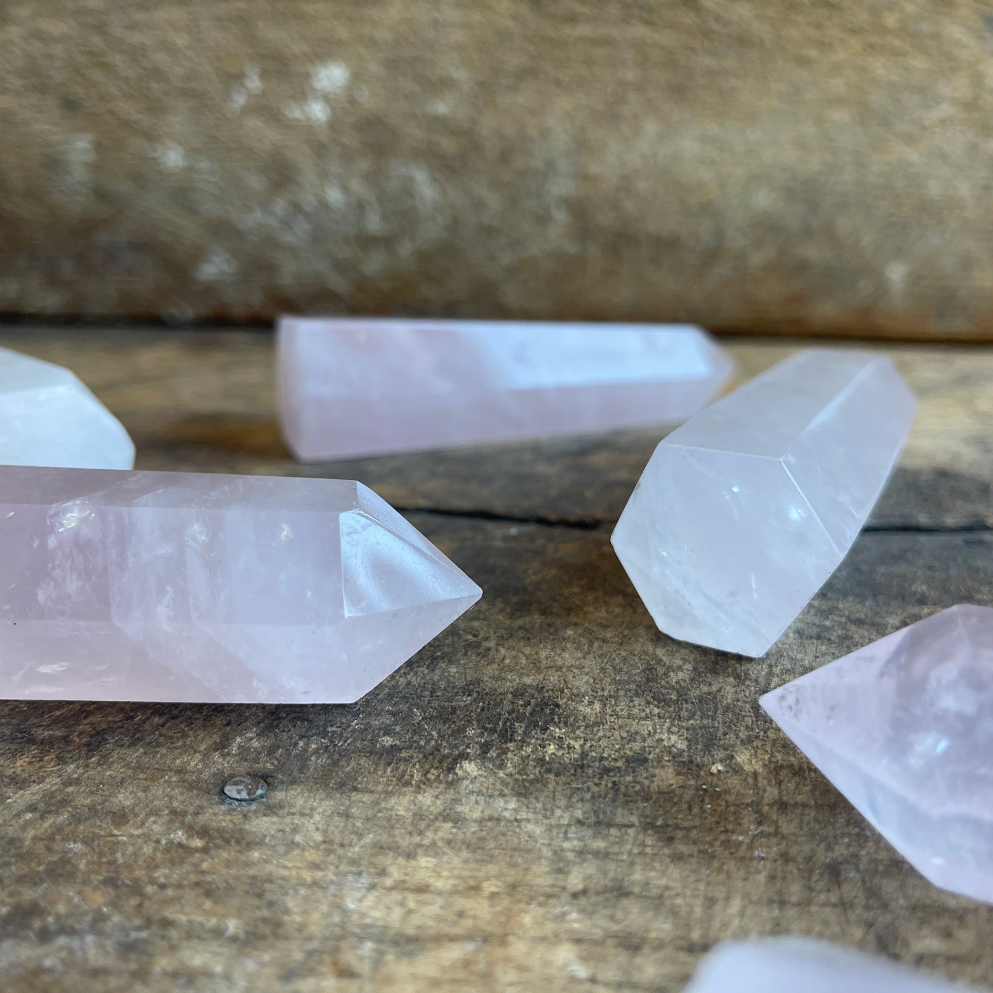 Rose quartz points on a wooden surface