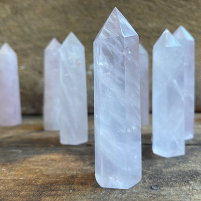 Rose quartz points on a wooden surface