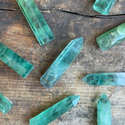 Green crystal points on a wooden surface
