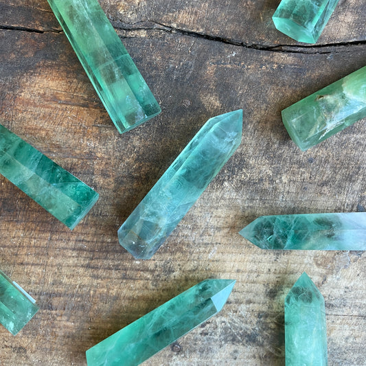 Green crystal points on a wooden surface