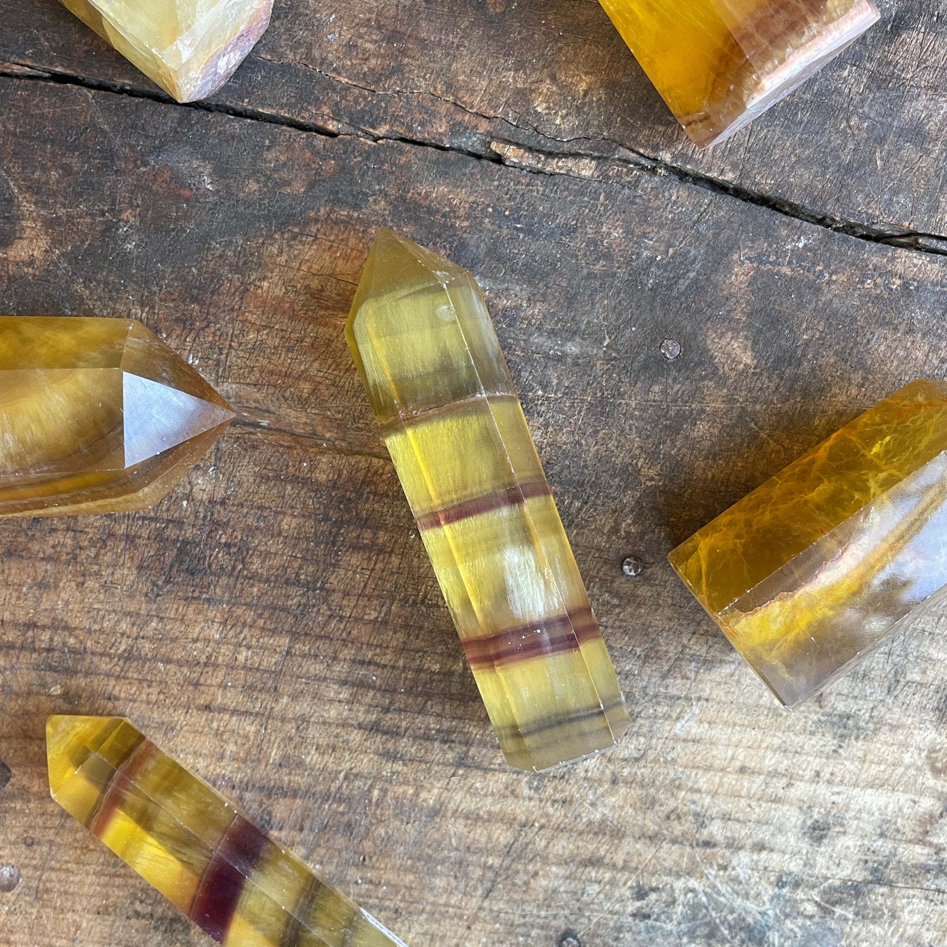 Yellow crystal points on a wooden surface
