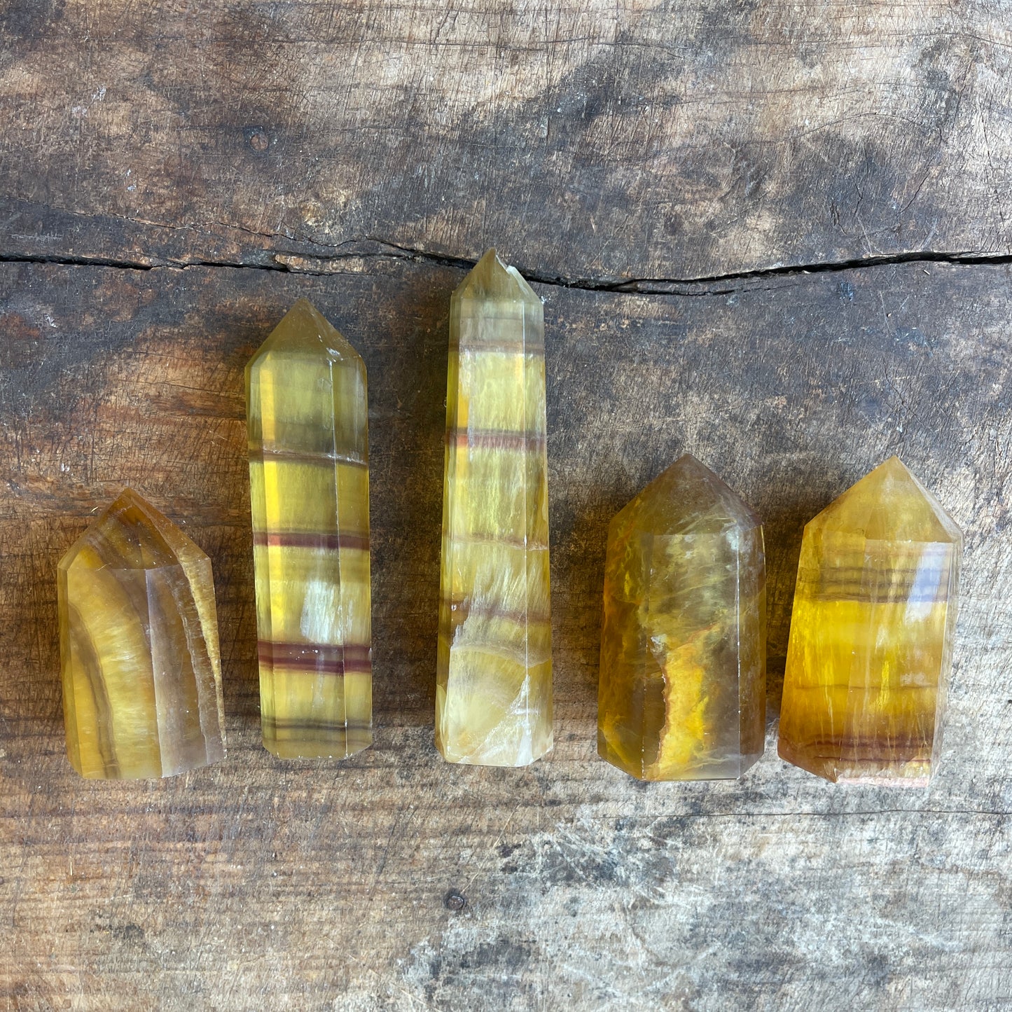 Five crystal points on a wooden surface