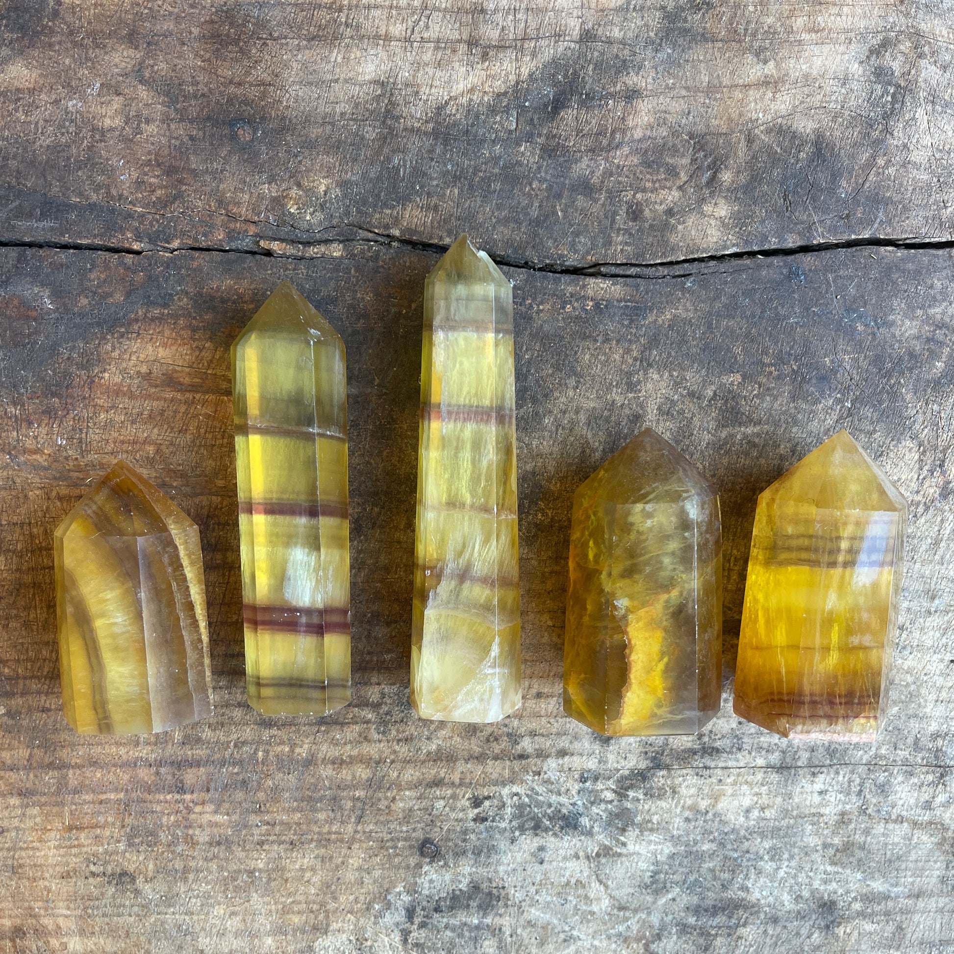 Five crystal points on a wooden surface