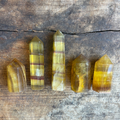Five crystal points on a wooden surface