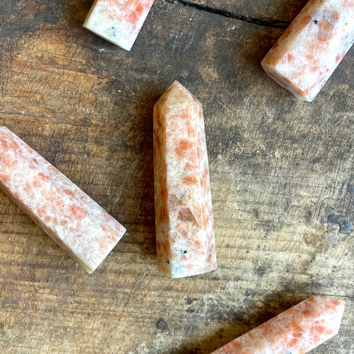 Sunstone points on a wooden surface