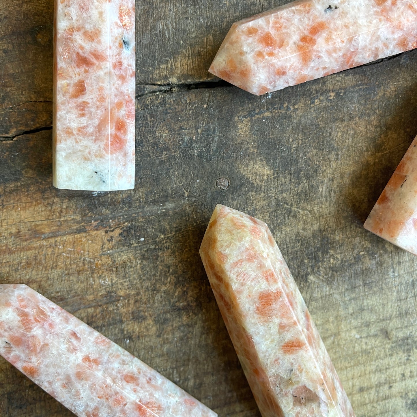 Sunstone points on a wooden surface