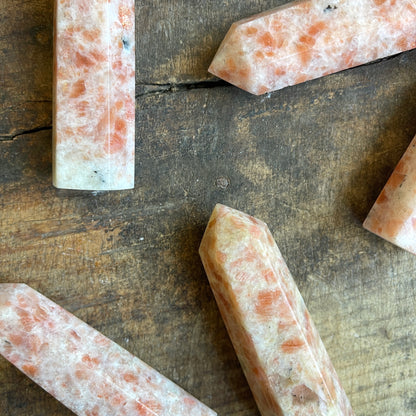 Sunstone points on a wooden surface