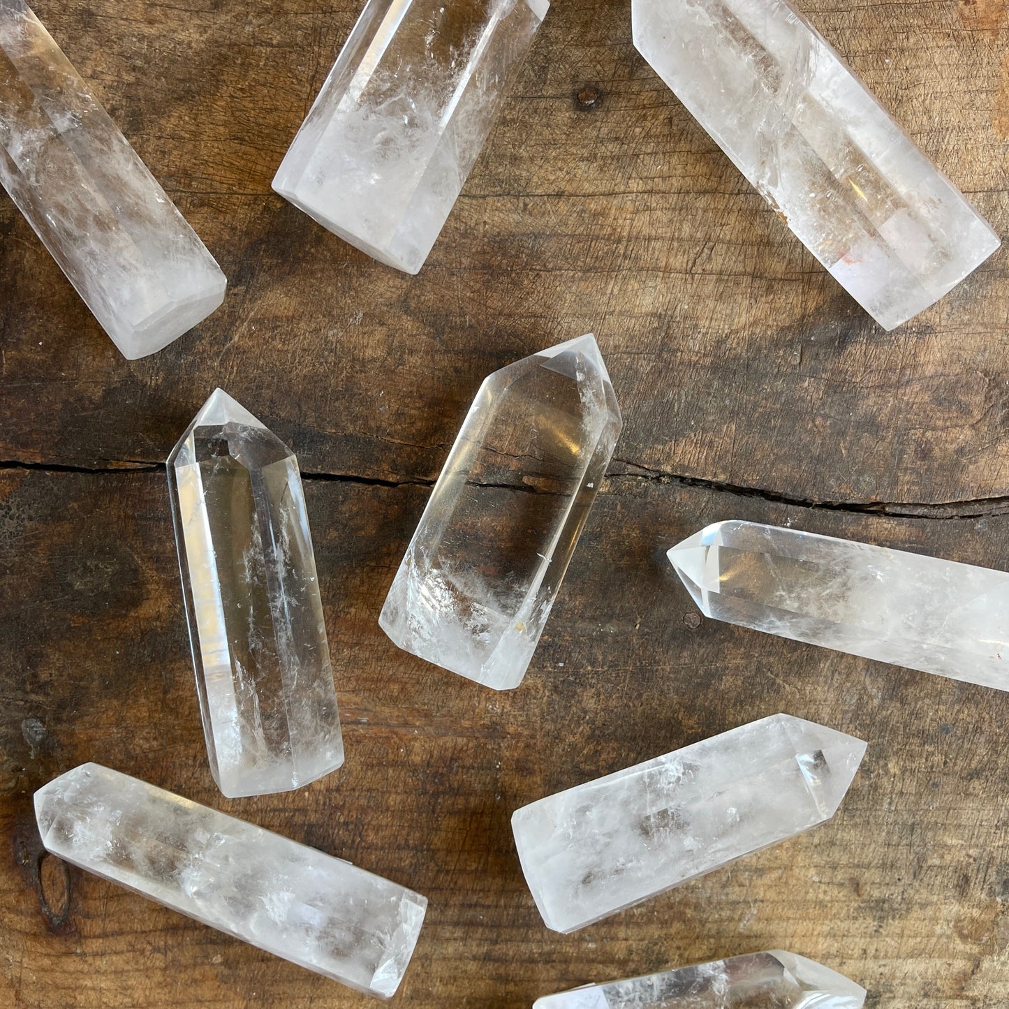 Clear crystal quartz points on a wooden surface