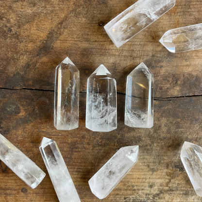 Clear crystal points on a wooden surface