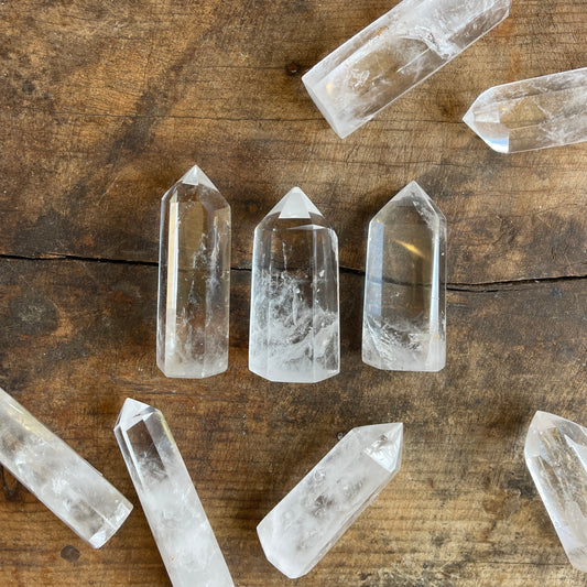 Clear crystal points on a wooden surface