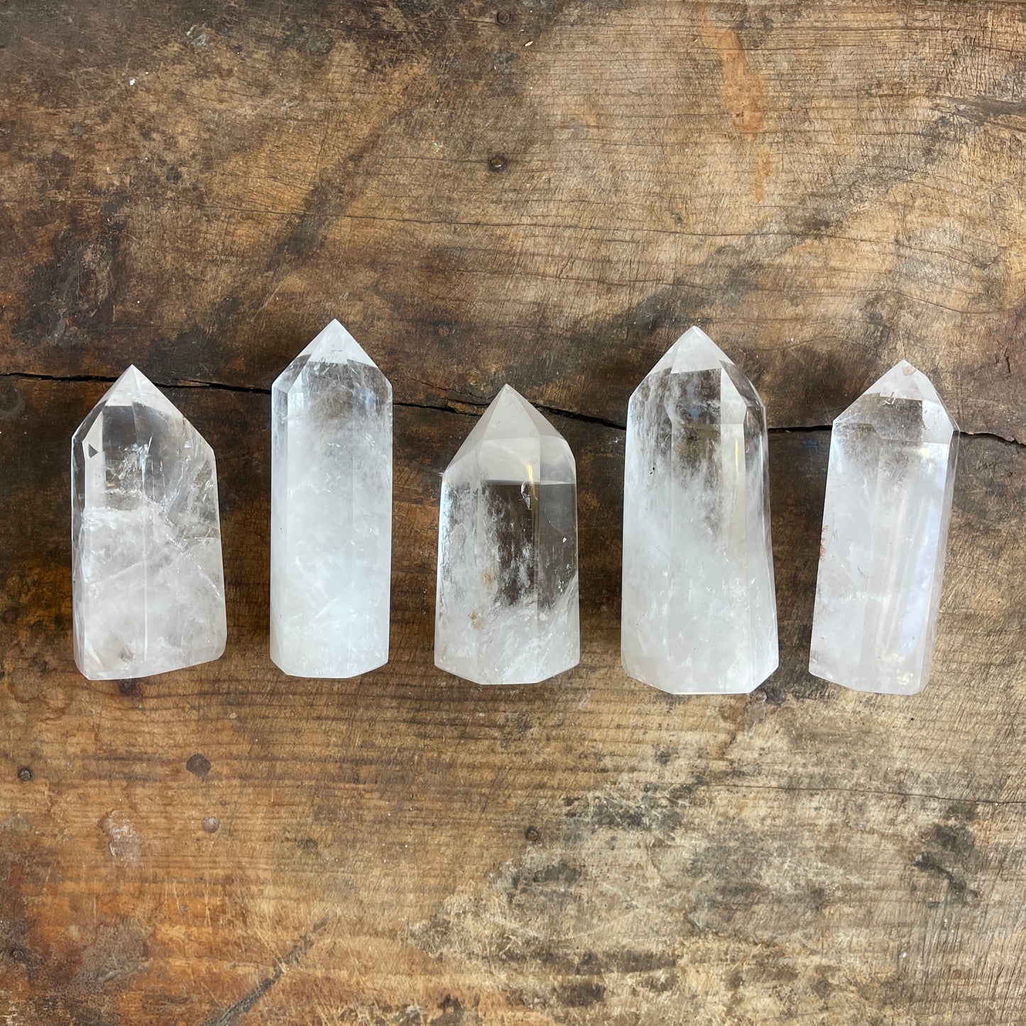 Six crystal points on a wooden surface
