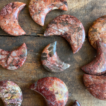 Jasper crescent moons on a wooden surface